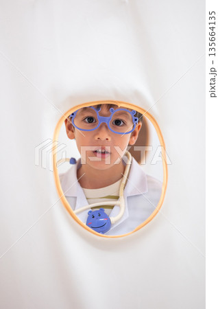 Happy Young Boy Wearing Doctor'S Outfit Inside Tent 135664135