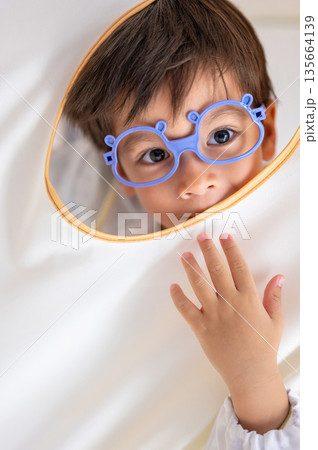 Curious Young Boy Posing Playfully With Medical Outfit Curious Young Boy Posing Playfully With Medical Outfit 135664139