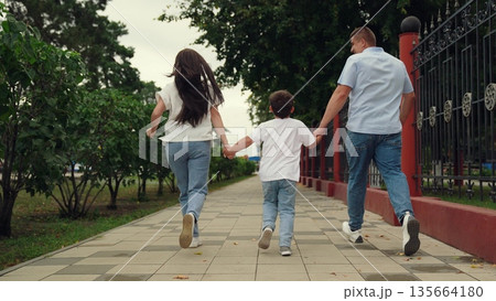 Group of people running happy green park, child man woman run hand, three people outdoors, family trip, happy family, young family with child son running, mother father boy happy family, Little Son 135664180