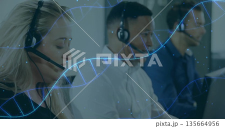 Handling calls three agents working at desks in open-plan office, with headsets and DNA helix Handling calls three agents working at desks in open-plan office, with headsets and DNA helix 135664956