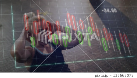 Lying female athlete performing sit-up in sportswear on dark gym floor with financial chart overlay 135665075