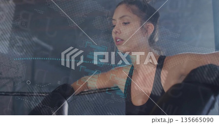Resting woman in boxing gym, sports bra, boxing gloves, ropes, bag, data overlay, copy space Resting woman in boxing gym, sports bra, boxing gloves, ropes, bag, data overlay, copy space 135665090