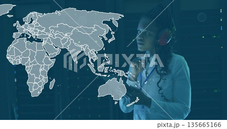 Operating interface engineer wearing red headset among server racks with map overlay, copy space 135665166