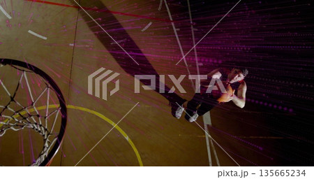 Athlete holding basketball at free throw line court, with hoop net and digital streaks, copy space 135665234