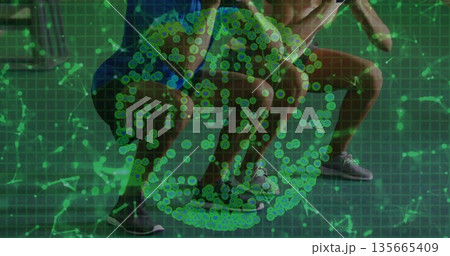 Squatting partners wearing lace-up running shoes at fitness studio, with green data overlay 135665409