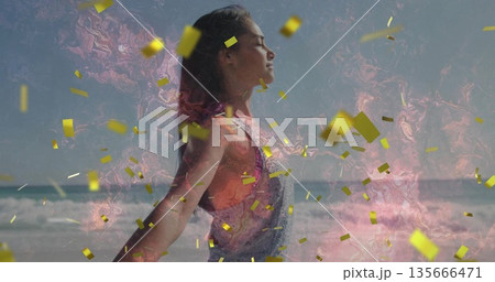 Standing woman wearing orange top in overalls, closing eyes on beach, golden confetti, pink swirl Standing woman wearing orange top in overalls, closing eyes on beach, golden confetti, pink swirl 135666471