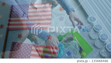 Sorting woman wearing blue sweater kneeling near window at home, with green bin and plastic bottles Sorting woman wearing blue sweater kneeling near window at home, with green bin and plastic bottles 135666486