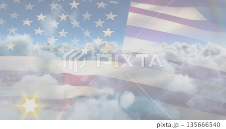 Overlaying American flag shining semi-transparently over high-altitude cloud layer, sun flare glow 135666540