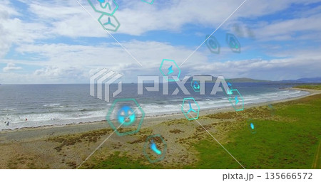 Translucent hexagonal overlay icons floating above surfers in wetsuits in coastal water, AR theme 135666572
