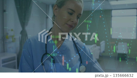 Monitoring nurse in blue scrubs with stethoscope studying floating data projections in patient room 135666632
