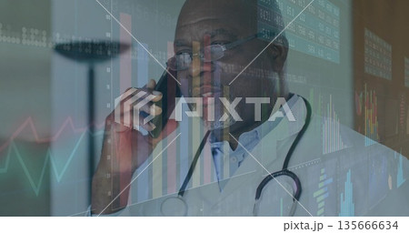 Senior doctor wearing stethoscope talking into smartphone in medical office, showing data overlays 135666634
