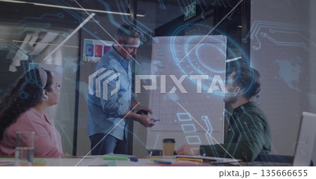 Presenting mature male wearing suit explaining strategy in business conference room, with flipchart 135666655