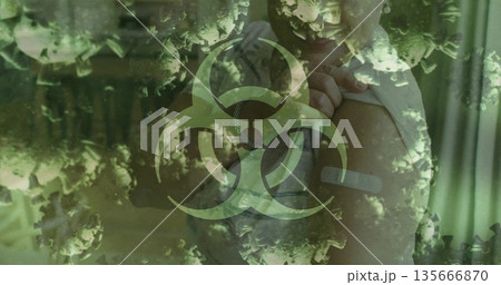 Pulling up shirt senior woman revealing bandaged arm in clinic, with biohazard and virus graphics 135666870
