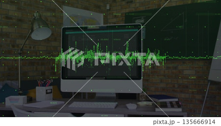 Displaying monitor showing green waveform at desk against brick wall, with lamp, keyboard and mouse 135666914