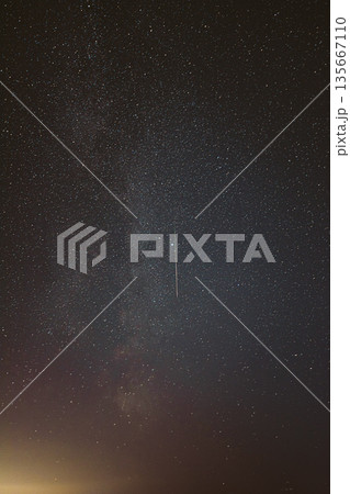 Real Night Sky Stars With Milky Way Galaxy. Natural Starry Sky Background with meteor trails lights. Background Night Starry Sky With Bright Stars And Meteoric Track Trail 135667110