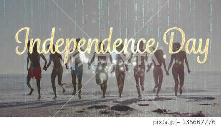 Running eight friends in swimwear holding hands at beach, gold Independence Day text green overlay 135667776