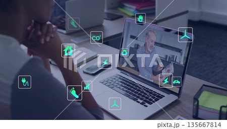 Leaning woman discussing eco goals on laptop at office desk with phone pens mesh organizer icons Leaning woman discussing eco goals on laptop at office desk with phone pens mesh organizer icons 135667814