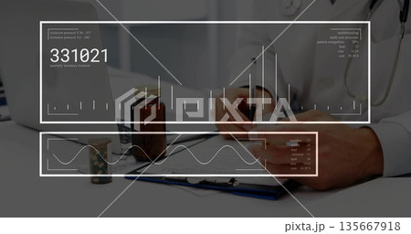 Writing doctor in lab coat with stethoscope filling out chart in doctor's office, with pill jars 135667918