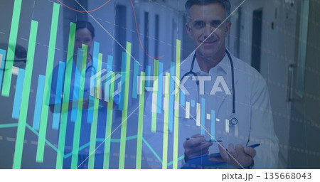 Monitoring doctor and nurse analyzing digital graphs in corridor, with stethoscopes and blue folder Monitoring doctor and nurse analyzing digital graphs in corridor, with stethoscopes and blue folder 135668043