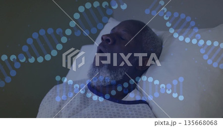 Resting mature man wearing hospital gown on white pillow in hospital bed, with blue DNA overlay 135668068