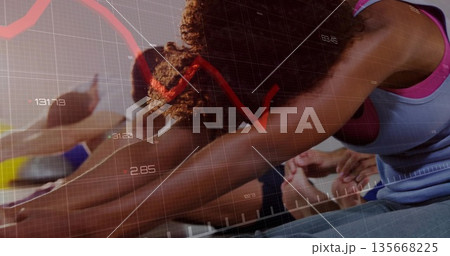 Performing yoga participants bending forward on mats in fitness studio, with grid overlay 135668225