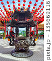 Thean Hou Temple in Kuala Lumpur, Malaysia, featuring an ornate incense burner and vibrant red lanterns 135669116