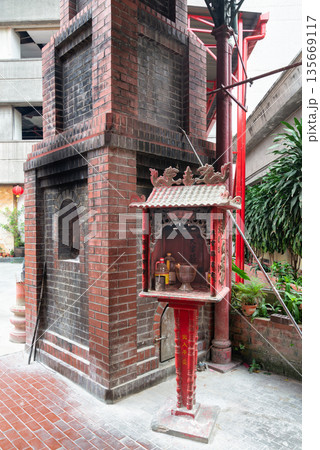 Traditional brick incense burner and altar with offerings at Sin Sze Si Ya Temple courtyard, Kuala Lumpur, Malaysia 135669117