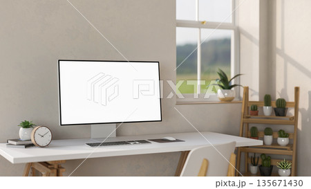 Blank screen computer aside clock and potted plant on white table aside wooden display shelf. 135671430