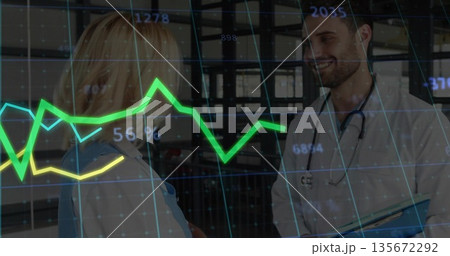 Doctor and nurse comparing graphs, data points in hospital corridor with stethoscope and clipboard 135672292