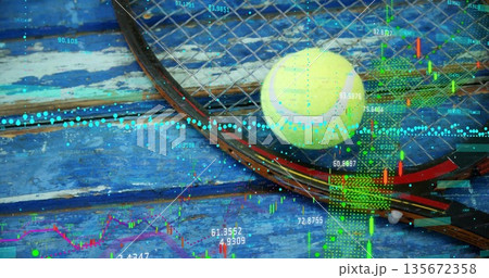 Displaying tennis racket, yellow ball on wood deck, with candlestick charts and data lines overlay 135672358