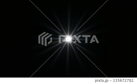 Bright starburst light effect with lens flare on a black background 135672782
