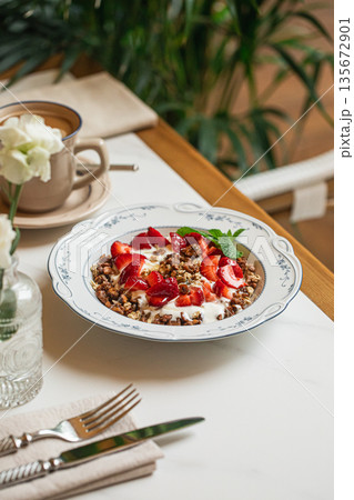 Granola bowl with yogurt and fresh strawberries 135672901