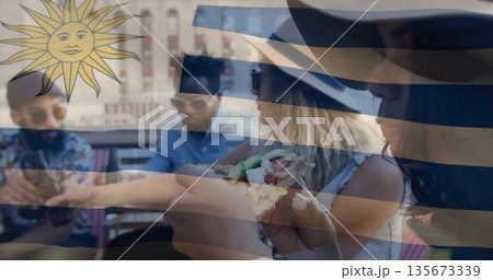 Eating group of friends sharing pizza at rooftop terrace table, wearing sunglasses and sun hat Eating group of friends sharing pizza at rooftop terrace table, wearing sunglasses and sun hat 135673339