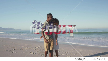 Strolling barefoot couple wearing floral shirt and sundress along sandy beach, with sunglasses Strolling barefoot couple wearing floral shirt and sundress along sandy beach, with sunglasses 135673354