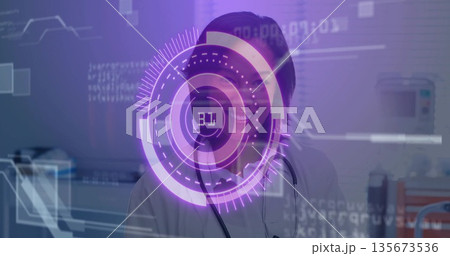 Interacting female doctor wearing white coat with stethoscope, using purple AR display in clinic 135673536