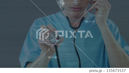 Presenting medical practitioner holding stethoscope diaphragm in exam room, with digital data 135673537
