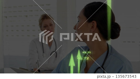 Listening nurse in scrubs engaging in clinic, with stethoscope and green arrow overlay, copy space 135673543