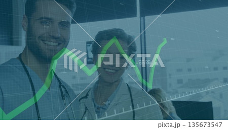 Standing medical professionals analyzing data in clinic, with stethoscopes and green graph overlay 135673547