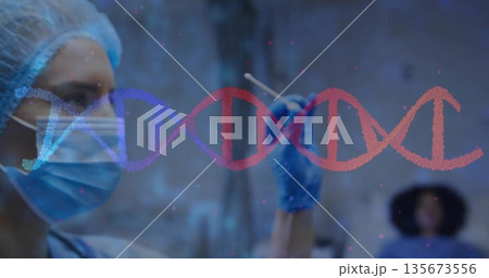 holding swab, nurse in scrubs, mask, examining DNA helix on patient in testing room, copy space 135673556