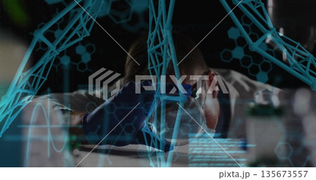 Leaning scientist in lab coat examining sample in lab, with magnifying glass, digital overlays 135673557