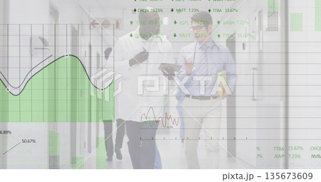 Walking medical team discussing data in hospital corridor, with tablet, stethoscope, digital graphs 135673609