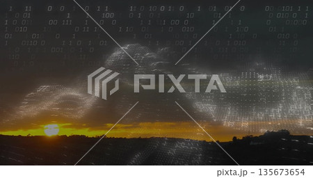 Streaming binary code wave forming data overlay across rural dusk sky, with sun glow over hills 135673654