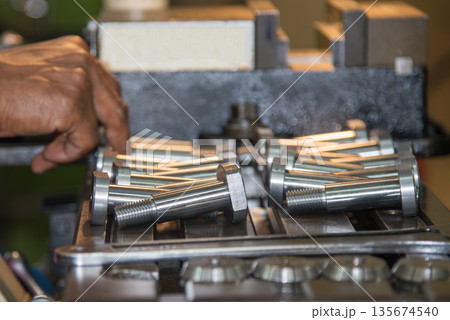 Metal Screw Parts Production in Workshop with Lathe Machine Operator 135674540