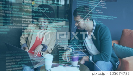 Reviewing code two engineers in blazers collaborating on laptop in office lounge with coffee cups Reviewing code two engineers in blazers collaborating on laptop in office lounge with coffee cups 135674785