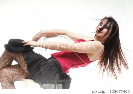 showgirl woman dance in red corset chair white isolated 135675469