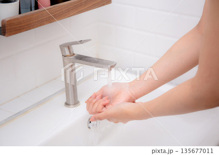 Closeup hands in sink with foaming soap, feeling hygienic and refreshed for prevention virus spread. Closeup hands in sink with foaming soap, feeling hygienic and refreshed for prevention virus spread. 135677011