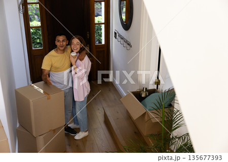 Young couple unpacking boxes in new home, feeling excited and happy together Young couple unpacking boxes in new home, feeling excited and happy together 135677393