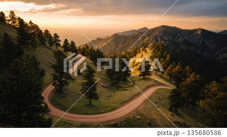 Winding Mountain Road Through Forest at Sunset 135680586