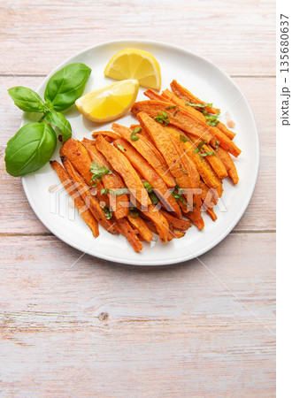 Roasted sweet potato fries with basil and lemon Roasted sweet potato fries with basil and lemon 135680637