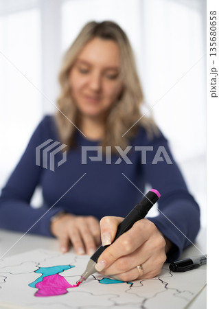 Woman Drawing With Markers to Express Feelings in a Bright Indoor Space During the Day Woman Drawing With Markers to Express Feelings in a Bright Indoor Space During the Day 135680658